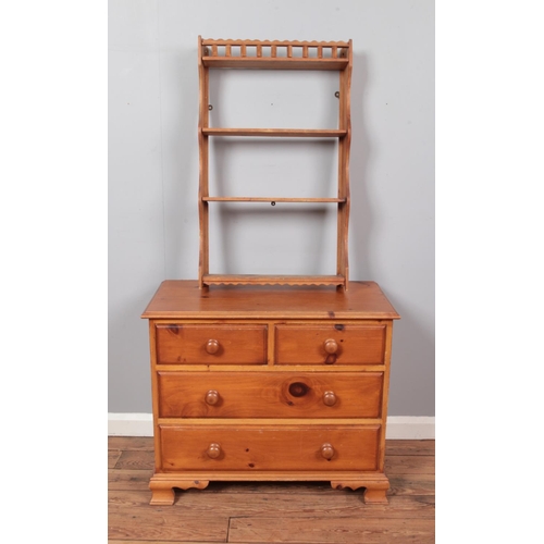 676 - A small pine two over two chest of drawers, together with a slender four-tier plate rack.