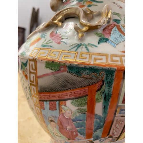 56 - A large late 19th/ early 20th century Chinese Canton Famille Rose vase. With gilt lion dog handles a... 