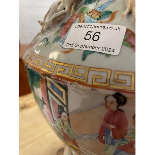 56 - A large late 19th/ early 20th century Chinese Canton Famille Rose vase. With gilt lion dog handles a... 