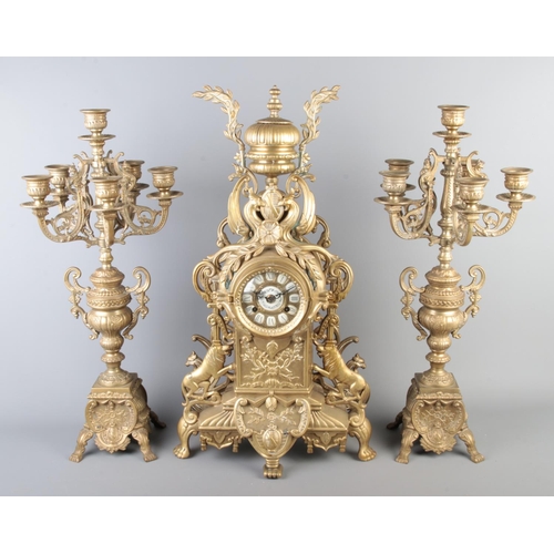 1 - A French brass clock garniture. Height 62cm.