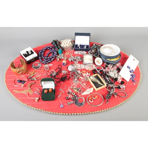 104 - A tray of costume jewellery. Includes silver pendant, chains, ring etc.