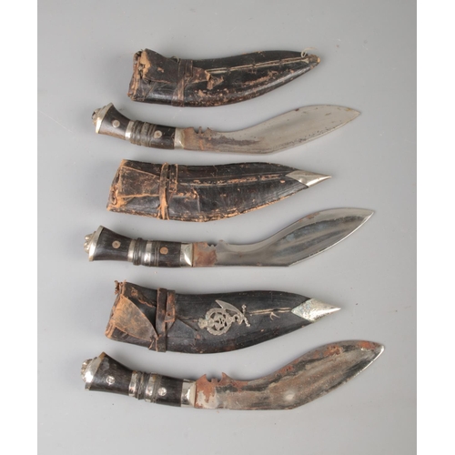 121 - Three Indian Kukri knives with sheaths; one bearing 5th Gurkha Rifles badge. Largest in sheath: 27cm... 