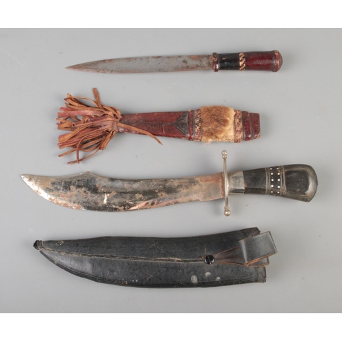 123 - A large Indian Kukri knife in sheath, together with a tribal dagger. CANNOT POST.