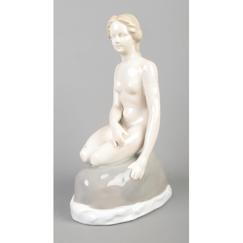 124 - A Copenhagen ceramic mermaid figure; 'By the Sea'. Bearing crown to base and 1801 impressed mark. He... 