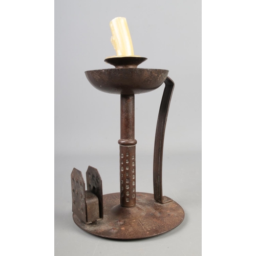 130 - A hand planished iron arts and crafts candlestick with integral match holder

Hx18cm