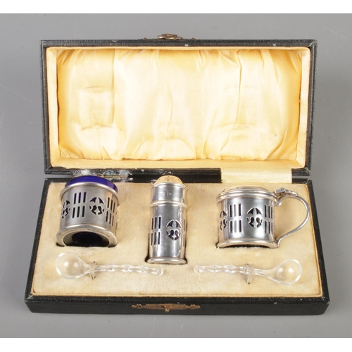 135 - A three piece silver cruet set with blue glass liners in its original box, assayed Birmingham 1922

... 