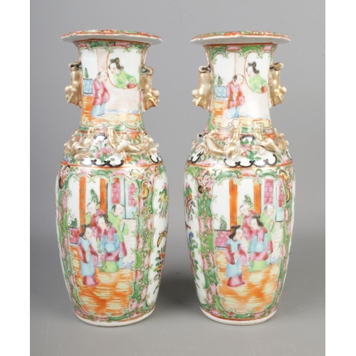 140 - A pair of 19th century Chinese Cantonese famille rose vases. 

Hx26cm