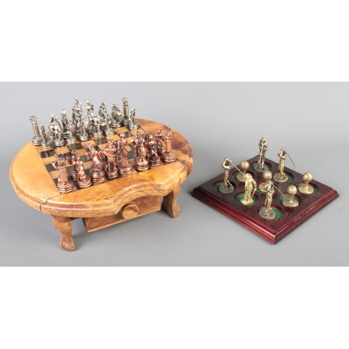 17 - An olive wood miniature table top chess set, together with a golf themed 'noughts and crosses' set.