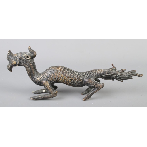 19 - A bronze figure of depicting a Chinese dragon. Approx. dimensions 22cm x 8cm.