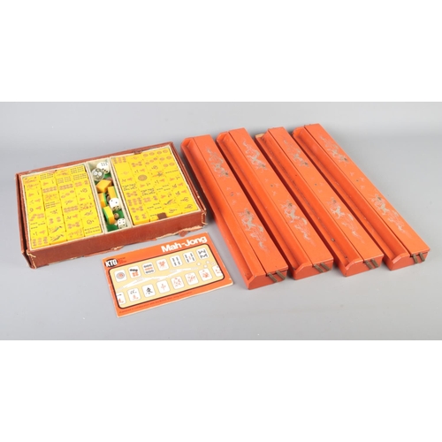 21 - A cased Mah-Jong set with four orange lacquered Mah-Jong tile holders with gold painted dragons