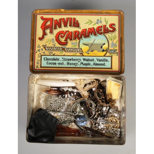 215 - A tin of costume jewellery, including vintage examples. Contains Swarovski butterfly necklace, cruci... 