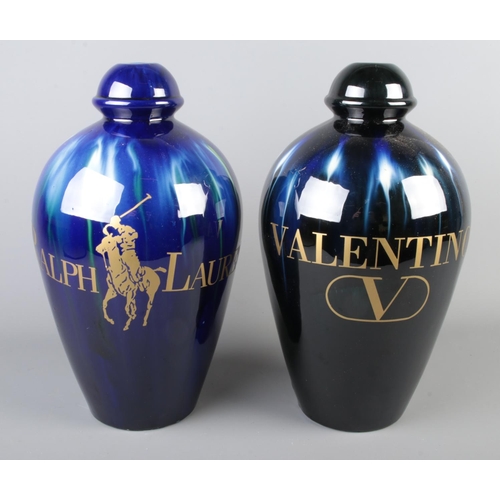 22 - A near pair of table lamp bodies each depicting a logo for Ralph Lauren and Valentino