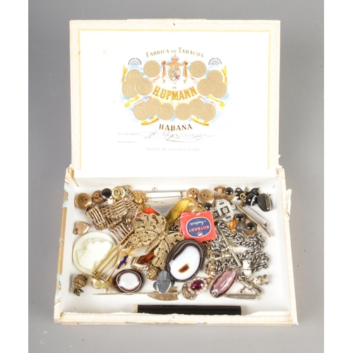 227 - A box containing an assortment of collectables, including gate bracelet, white metal fob chain, butt... 