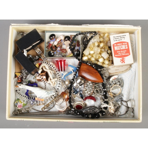 229 - A box containing a quantity of collectables, to include Golly sporting badges, silks, dress rings, b... 