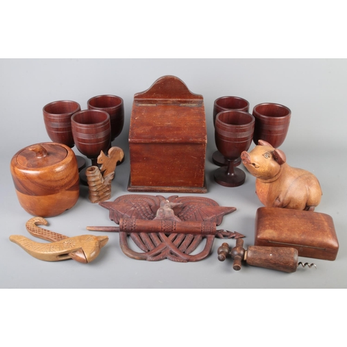 23 - A collection of treen including tobacco jar, salt box, nutcracker, corkscrew, carved bird plaque etc