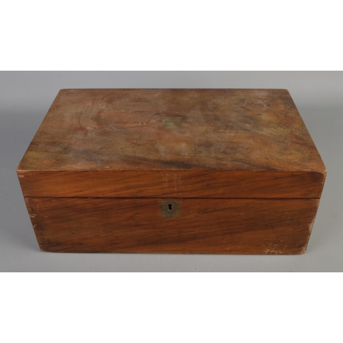 233 - A Victorian walnut writing slope with brass inlaid decoration.