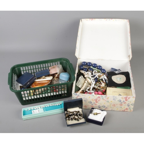 240 - Two boxes of assorted costume jewellery to include simulated pearls, beaded necklaces, bracelets, ke... 