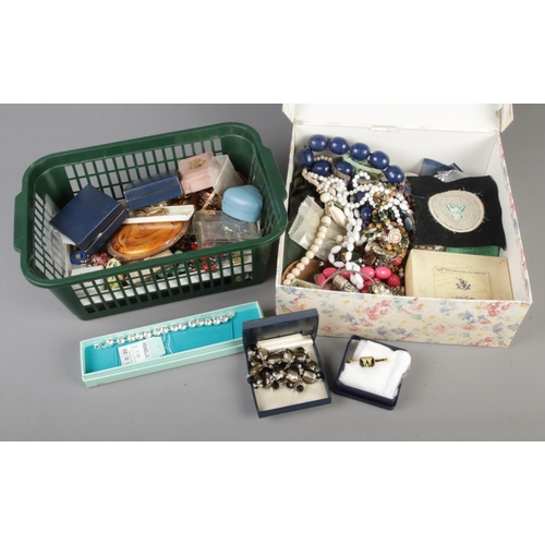 240 - Two boxes of assorted costume jewellery to include simulated pearls, beaded necklaces, bracelets, ke... 