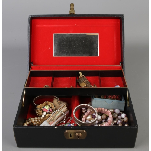 243 - A vintage jewellery box with contents of assorted costume jewellery to include beaded necklaces, bra... 