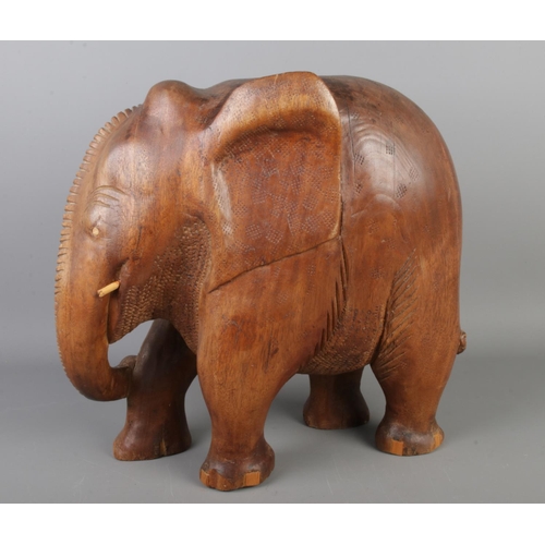 246 - A large carved wooden elephant ornament, height 37 x width 38cm