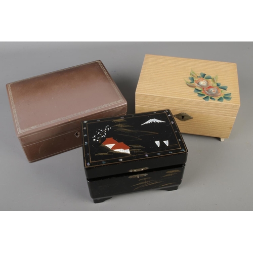 248 - Three vintage jewellery boxes containing a small quantity of costume jewellery to include brooches, ... 