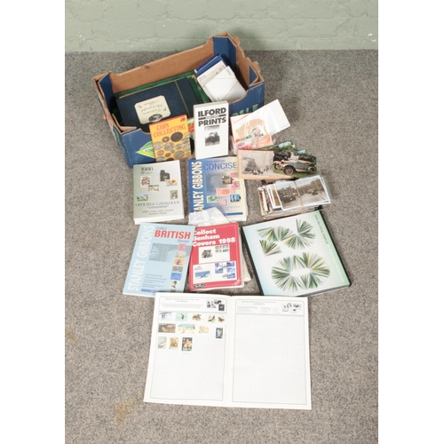 265 - A box of assorted stamps, postcards, photographs and collecting guides to include Royal Mail Special... 