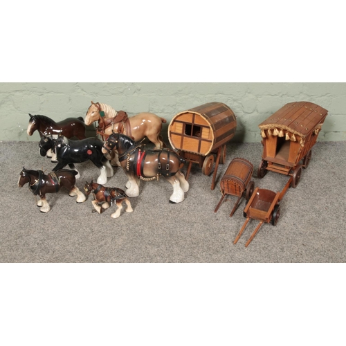 287 - A collection of ceramics shire horses and wooden carts to include barrel shaped examples.