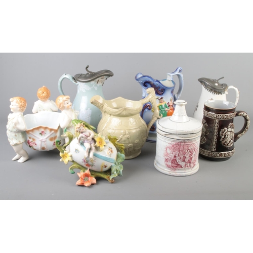 34 - A collection of antique ceramics including porcelain cherub bowl, tobacco jar, jugs etc