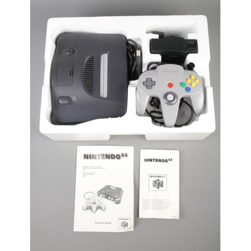 406 - A boxed Nintendo 64 console, together with four game cartridges. Contains Diddy Kong Racing, Gex64, ... 