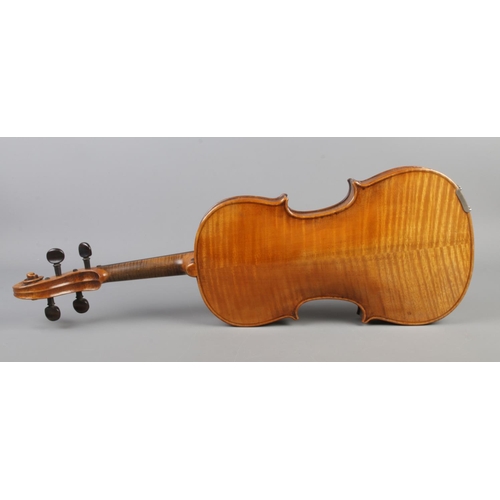 407 - A cased violin with two bows. Having 14 inch two piece back.