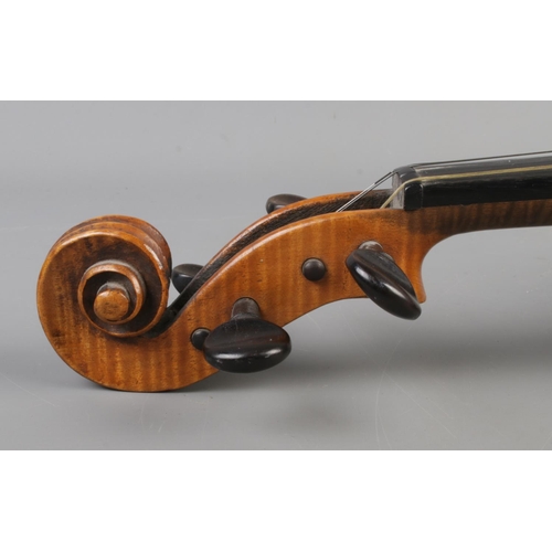 407 - A cased violin with two bows. Having 14 inch two piece back.