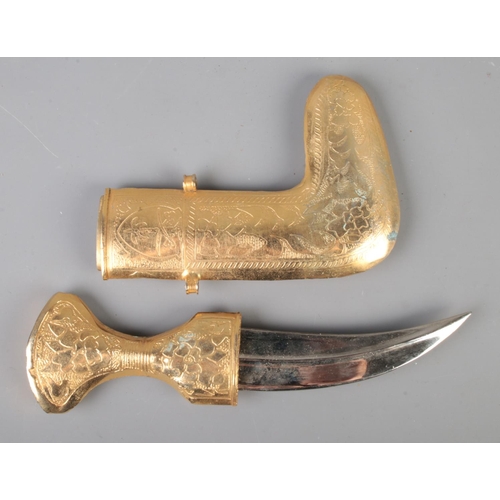 42 - A middle eastern Jambiya dagger featuring heavily decorated gold coloured scabbard and hilt.
CANNOT ... 