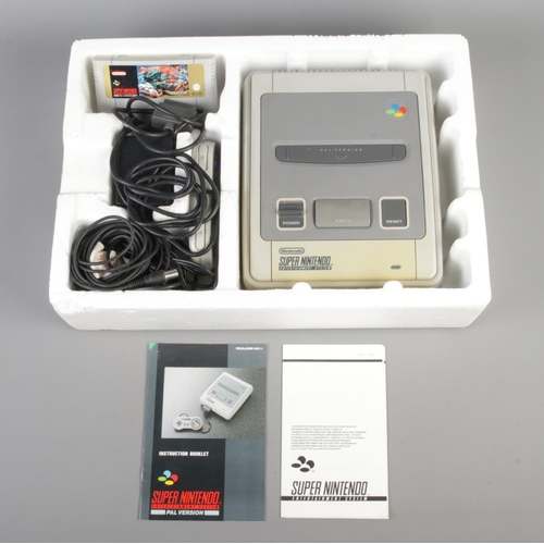 408 - A boxed Super Nintendo console system, Street Fighter II edition, together with four additional game... 