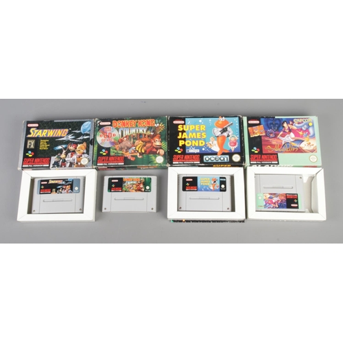 408 - A boxed Super Nintendo console system, Street Fighter II edition, together with four additional game... 