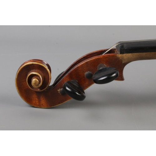 411 - A wooden cased violin with bow. Having two piece 14 inch back.