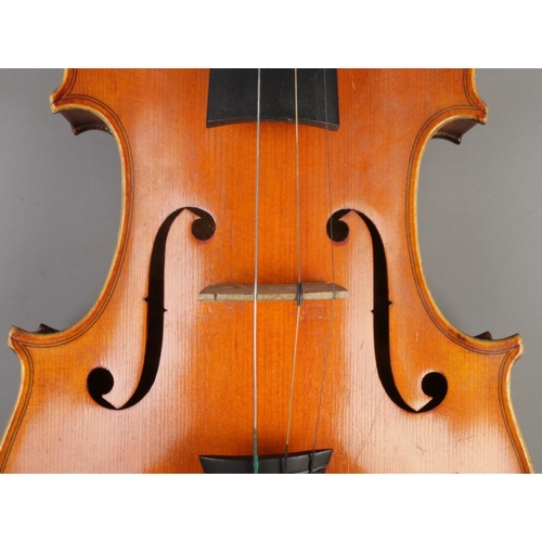 411 - A wooden cased violin with bow. Having two piece 14 inch back.