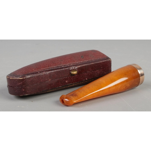 55 - A cased amber and 9ct Gold rimmed cheroot holder.