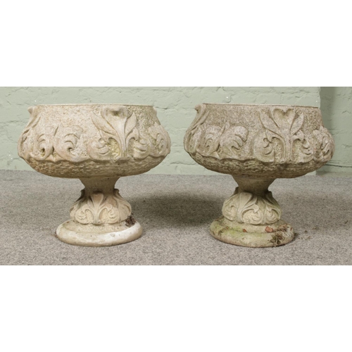 440 - A pair of concrete garden bowl planter raised on short pedestal bases. Approx. height 34cm.