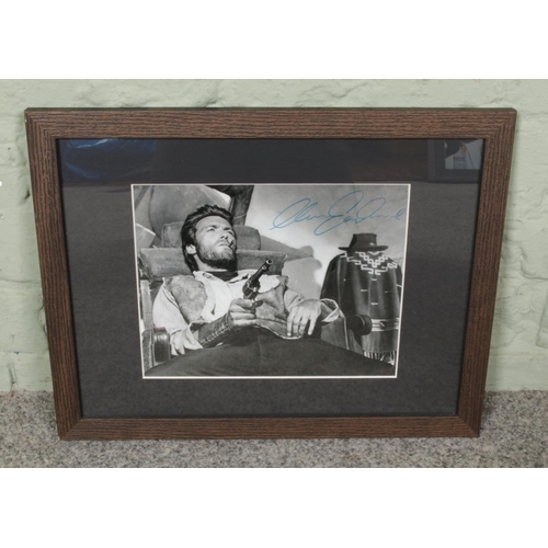 471 - Framed Clint Eastwood autographed,  black & white, comes with a Certificate of Authenticity at the b... 