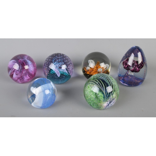 64 - Six Caithness glass paperweights. Includes Trapeze, Cinnabar, Aries, Fiesta, Moonflower and Cauldron... 