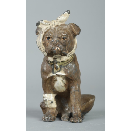 65 - An early Twentieth Century Bergman style cold painted base metal figure of a dog, wrapped in bandage... 