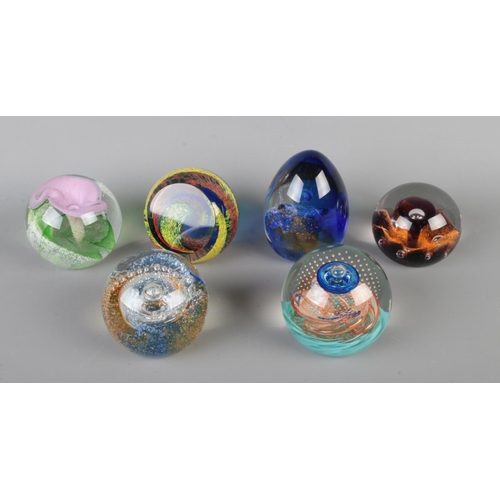 66 - Six Caithness glass paperweights. Includes Sunflower, Time Tunnel, Calypso, Energize, Origin and Cos... 