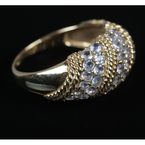 510 - A 9ct Gold ring set with six rows of tanzanite stones, separated by a rope twist border. Size R½. To... 