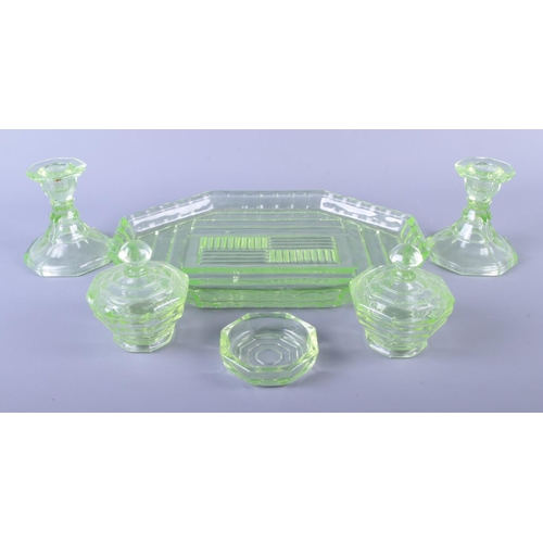 7 - A green uranium glass dressing table set, six pieces