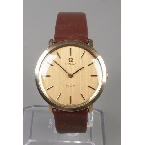 524 - A gents 9ct gold Omega De Ville manual wristwatch. Having champagne dial and baton markers.