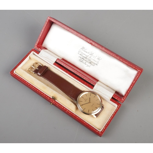 524 - A gents 9ct gold Omega De Ville manual wristwatch. Having champagne dial and baton markers.