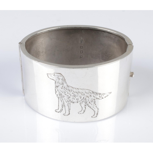 559 - A silver bangle with engraved dog design, assayed Birmingham 1933, 49.5g