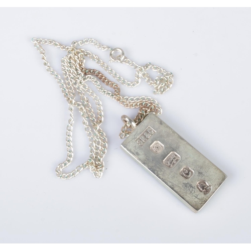 568 - A silver ingot on chain hallmarked for Sheffield 1977 by SR&C. Total weight 37.54g.