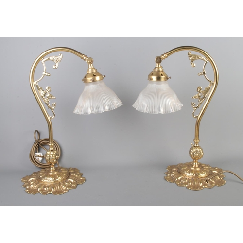 77 - A pair of brass and glass desk lamps.