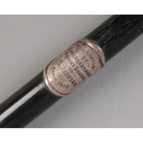 594 - An Edwardian silver mounted and ebonised conductors baton, with inscription to central mount for 'Pr... 